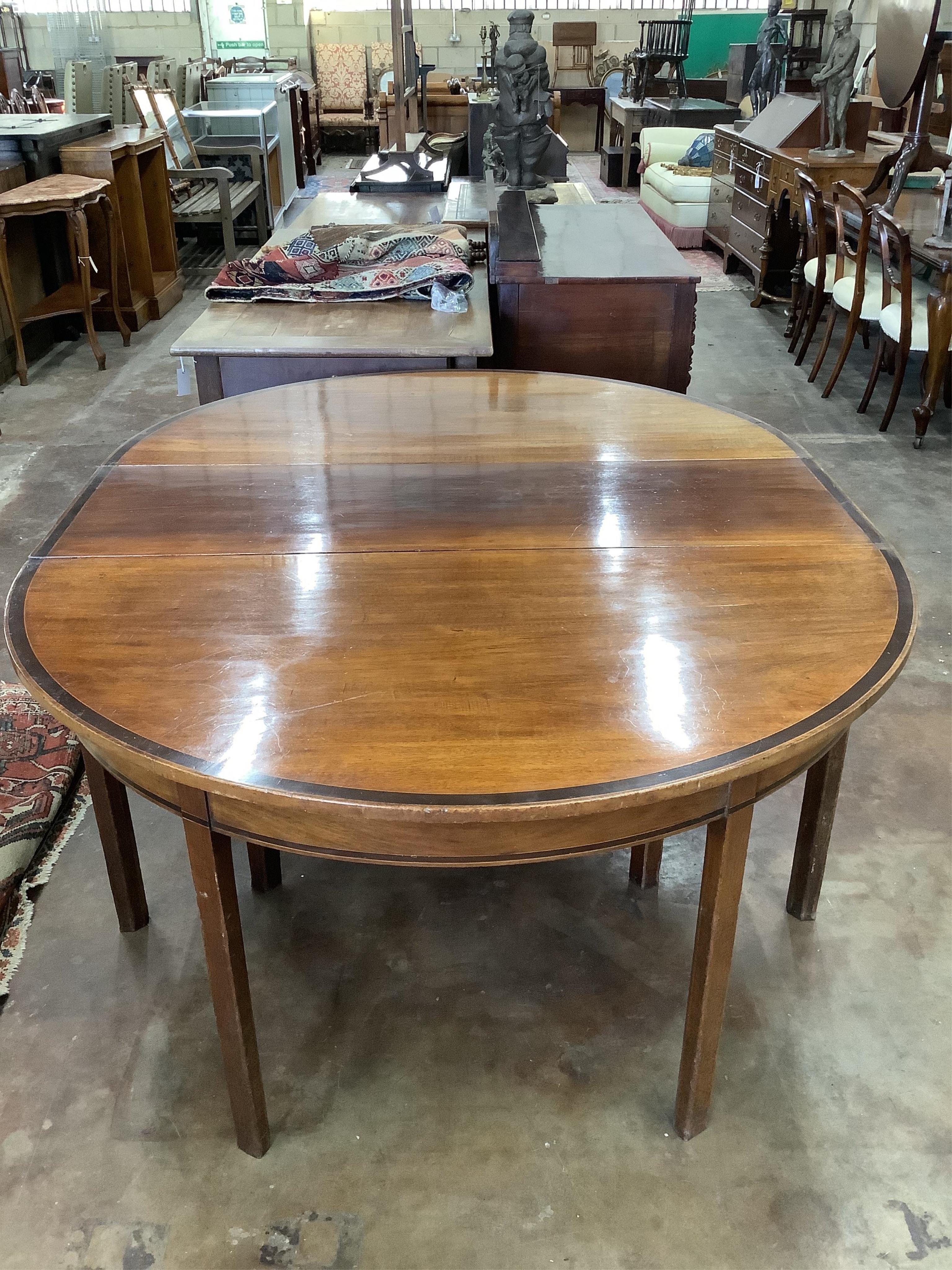 A George III banded mahogany D end extending dining table, 178cm extended, one spare leaf, depth 137cm, height 72cm. Condition - fair